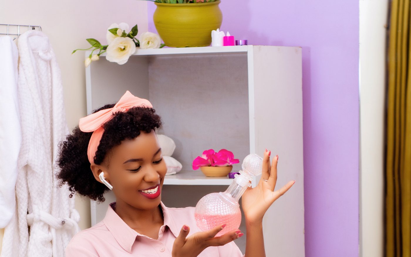Ease Spa staff member holding a bottle of house body oil