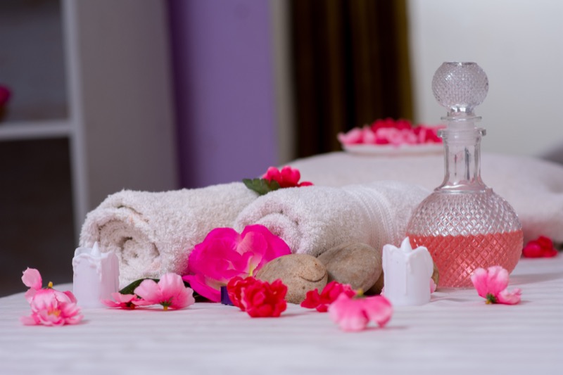 Massage oil and warm towels ready for a body scrub treatment