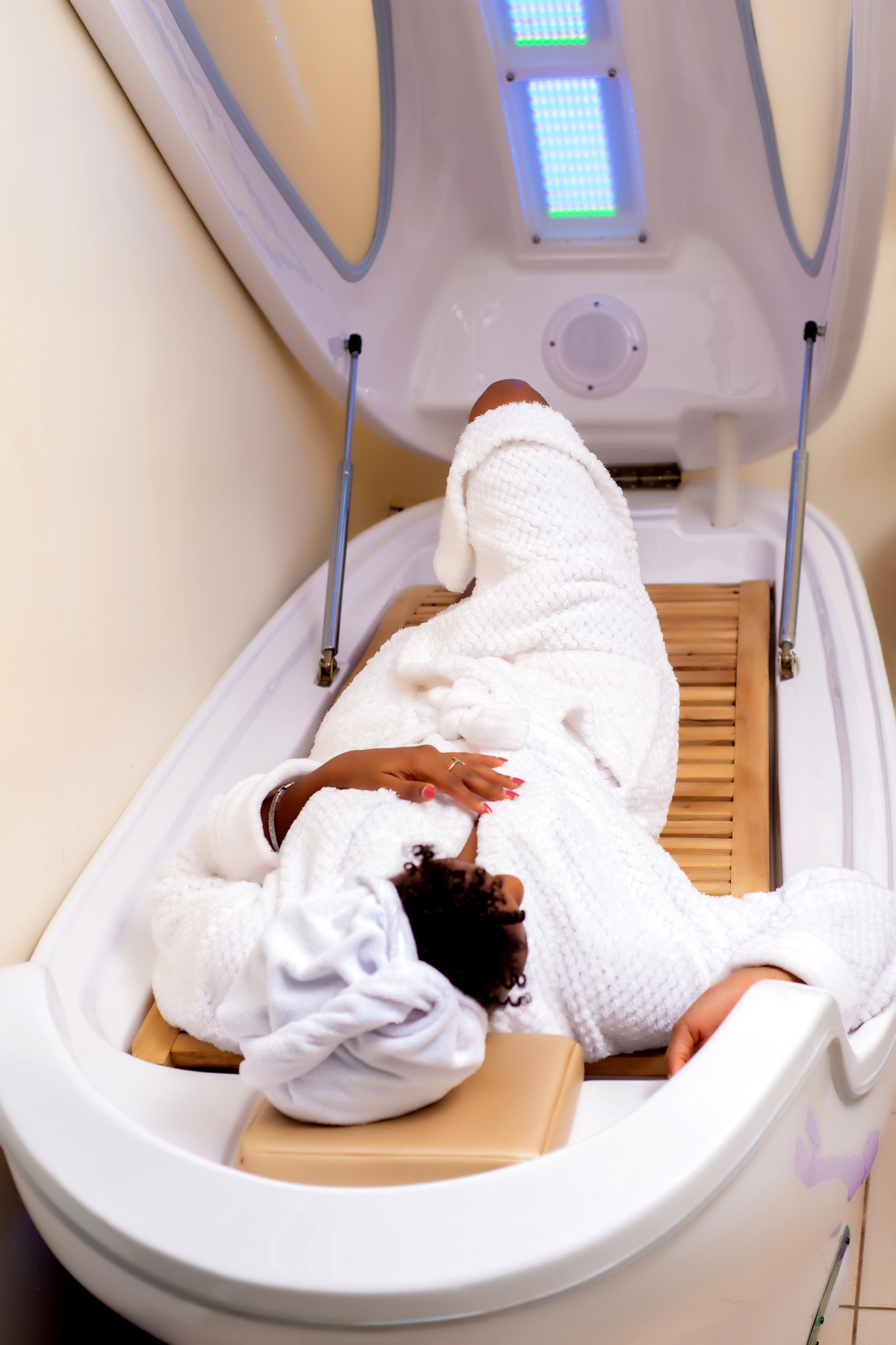 Guest relaxing inside the ozone wellness capsule at Ease Spa