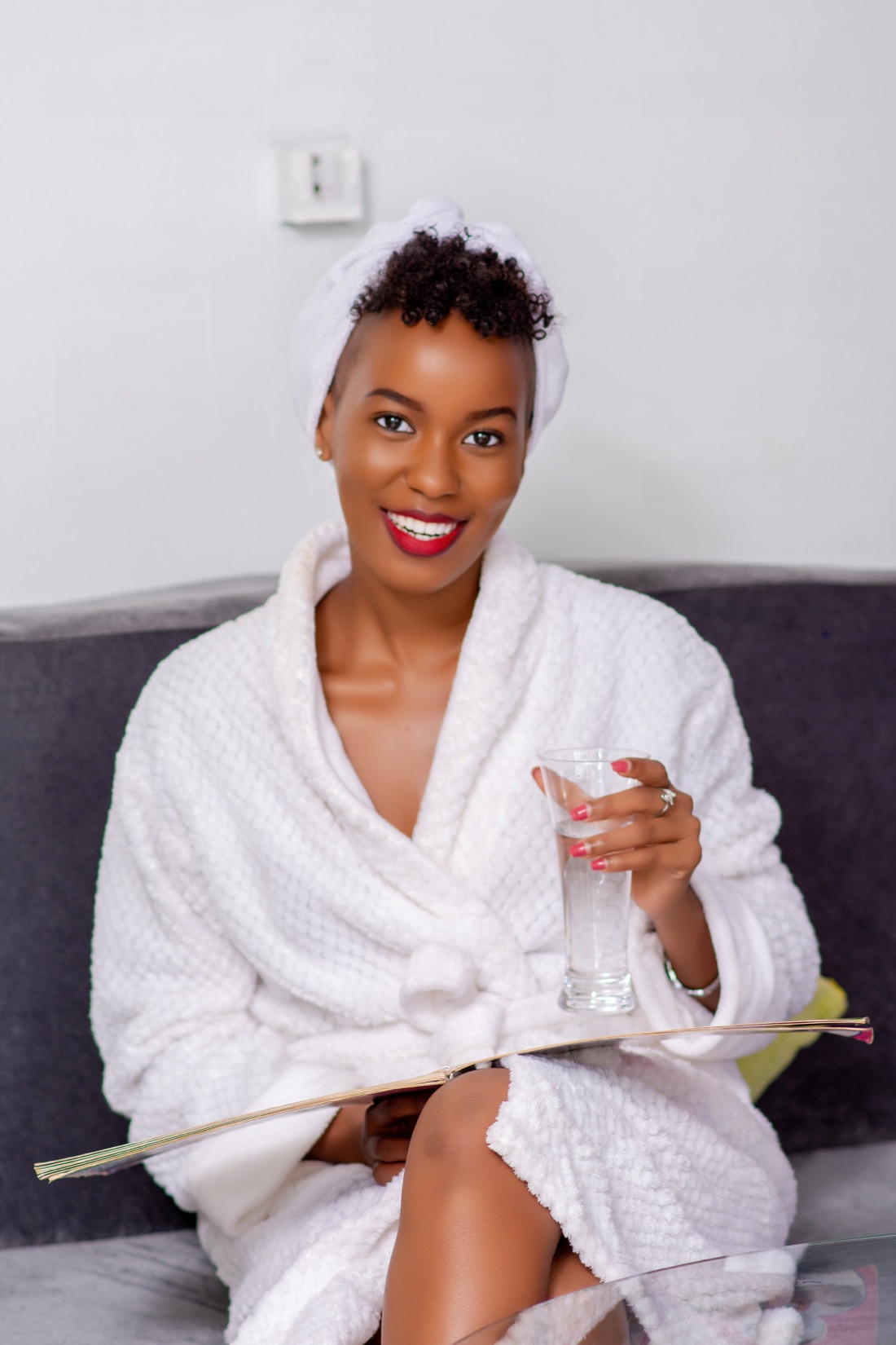 Guest relaxing in a robe with a refreshing drink after treatment